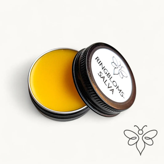 Öppen 10 g burk med BivaxSalva Mini Ringblomma från EneboBee, visande den gyllengula salvan.