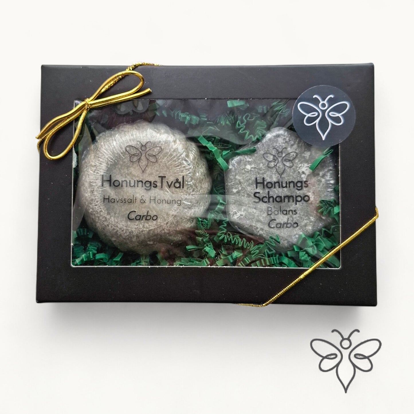 Stängd presentask, Carbo, med honungstvål och schampokaka från EneoBee, svart ask med fönster och guldsnöre.