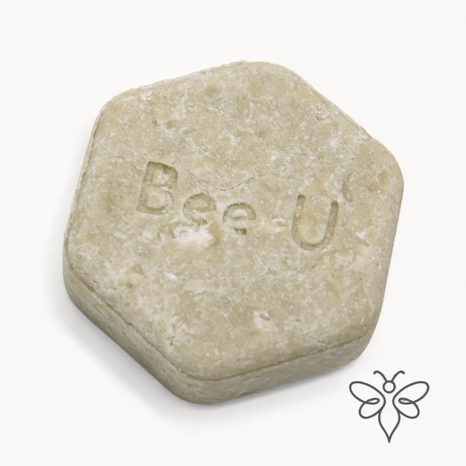 EneboBee schampokaka Omsorg Verde, handgjort honungsschampo, en ljust olivgrön melerad hexagon.